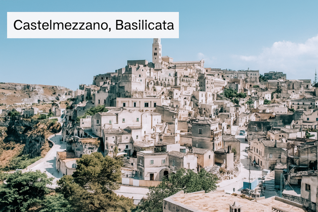 Mountain village of Castelmezzano, Basilicata, with stone houses nestled among dramatic rocky peaks at sunset.